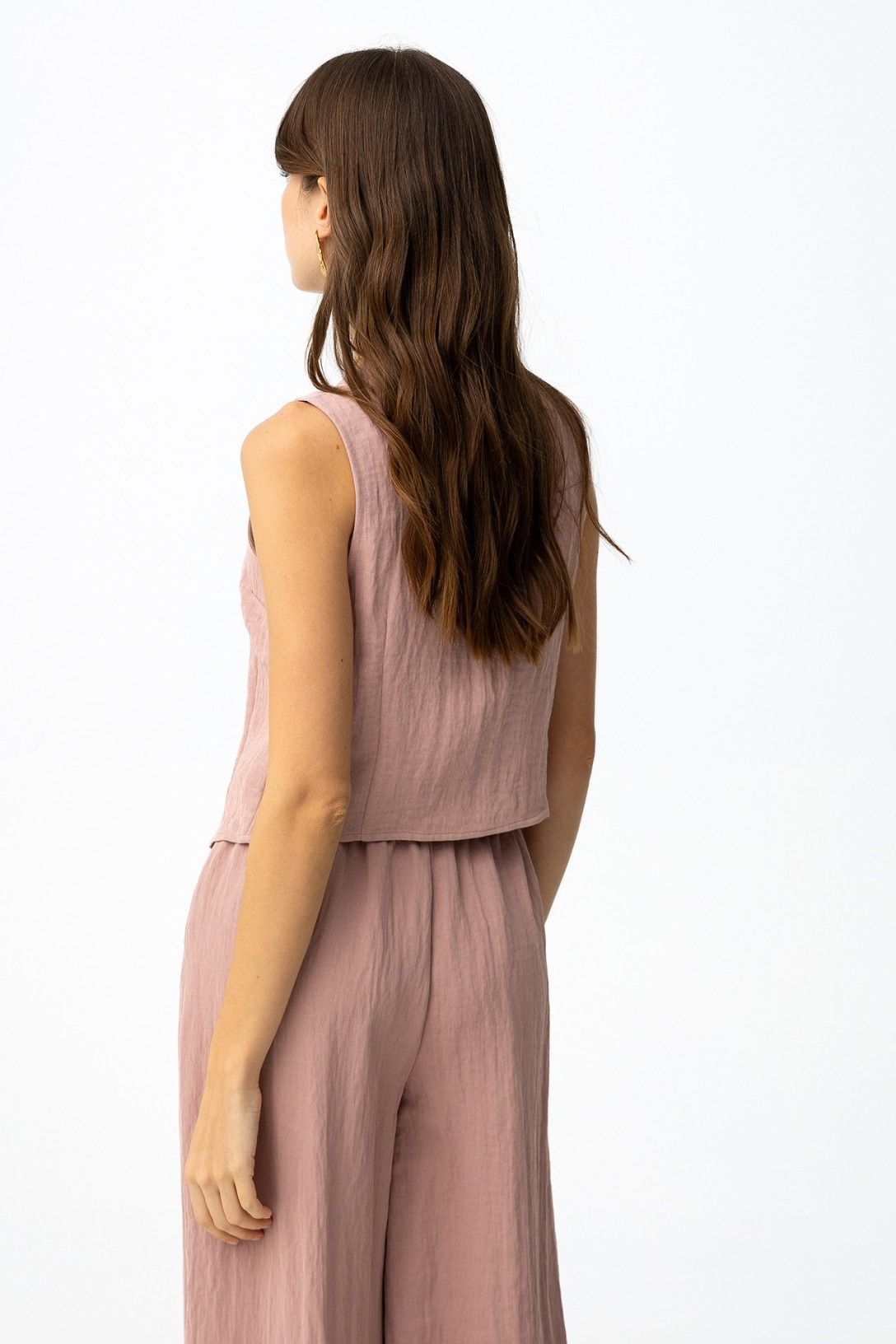 Prenda de mujer estilo chaleco abotonado en color rosa.
