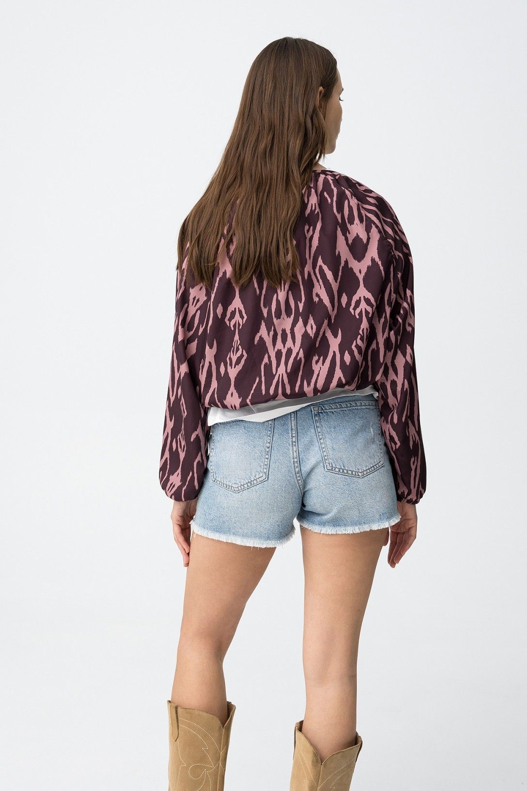 Detalle de la gomilla elástica en la parte baja de la chaqueta rosa.